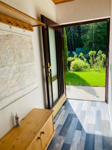 a room with a large window and a wooden table at Enjoy Hiking in Aufseß