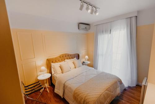 a bedroom with a large bed and a window at Hotel Petrópolis in Nova Petrópolis