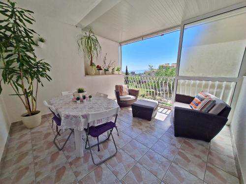 a living room with a table and some chairs at Apartment Nina Marie II in Split