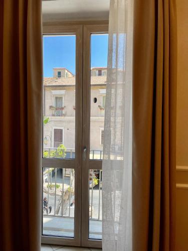 a window with a view of a building at Terrazzo Del Borgo in Tropea