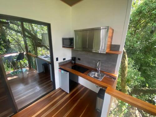 a kitchen in a tiny house with a sink at Sweet Jungle in Quesada