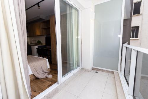 a sliding glass door leading into a living room with a kitchen at 360 Suítes Sé in Sao Paulo