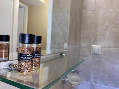 a bottle of spices sitting on a counter in a bathroom at Two-storey Mansion at the Sea in rkadiko Chorio
