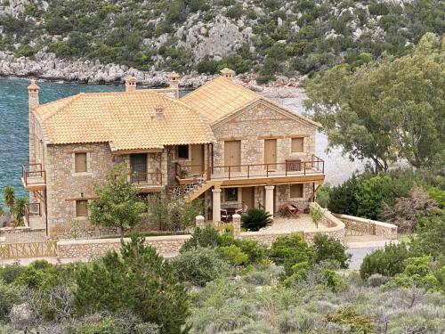 a large house on the side of the water at Two-storey Mansion at the Sea in Arkadiko Chorio