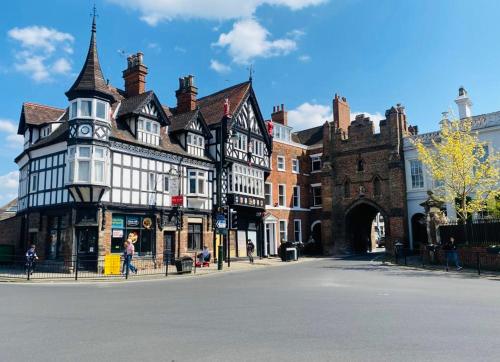 an old building with a clock tower on a street at Beverley Snug in Beverley