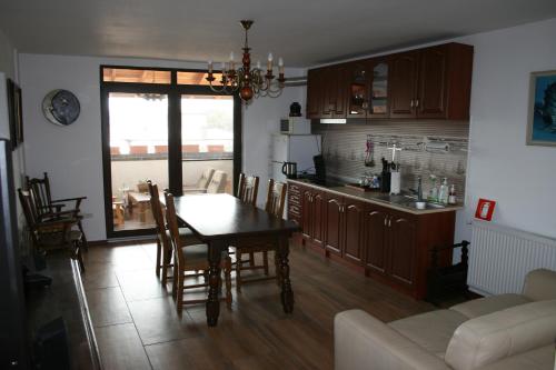 a kitchen and dining room with a table and chairs at Colev Rooms in Focşani