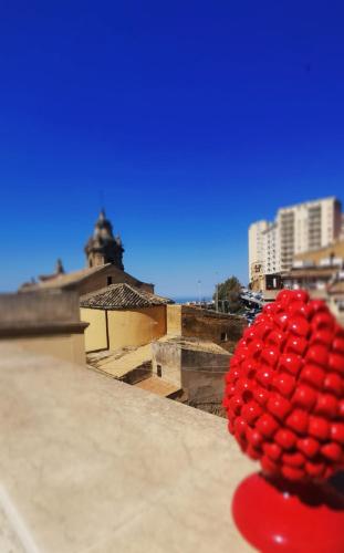 a bunch of red apples sitting on top of a building at A due passi dal centro Sweet Rooms in Agrigento