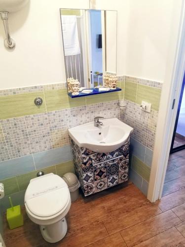 a bathroom with a toilet and a sink at A due passi dal centro Sweet Rooms in Agrigento