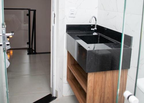 a bathroom with a black sink in a room at Loft Rio Verde in Rio Verde