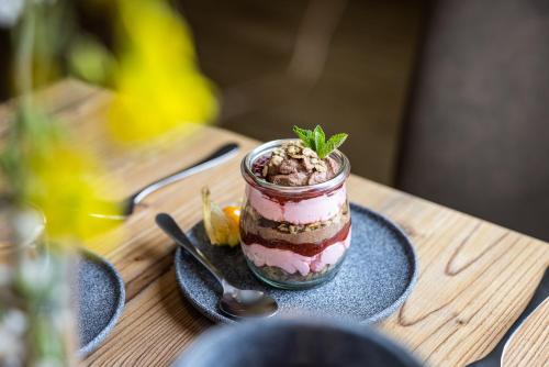 a dessert in a glass jar on a table at Der Alpenblick in Sankt Johann im Pongau