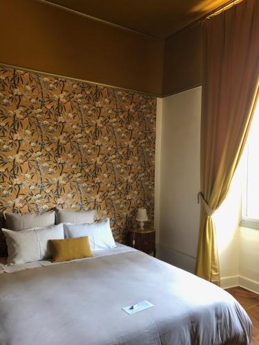 a bedroom with a large bed with a wall mural at Château de Charmeil- Vichy chambres d'hôtes in Charmeil