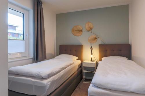 En eller flere senge i et værelse på Haus Treibholz Apartment 6