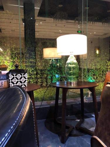 a table with a lamp on it in a room at Empyrean Dhaka City Centre in Dhaka