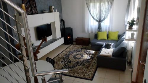 a living room with a couch and a tv at Casa Rosa dei Venti in Cividale del Friuli
