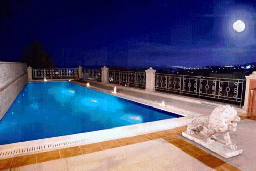 a swimming pool on top of a building at night at Casa dell' Aristea in Atsipopoulo