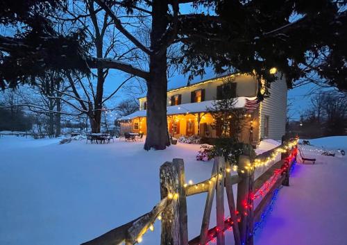 a house with christmas lights in the snow at Galvanized America Inn & Art Gallery in Doylestown