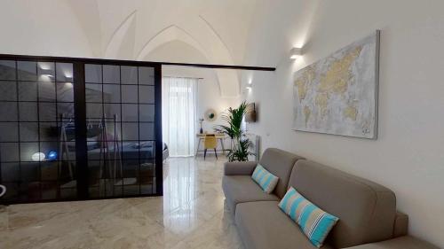 a living room with a couch and a map on the wall at Zephir Apartments in Brindisi