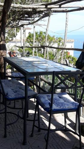 a picnic table and two chairs on a patio at Casa Barbara in Amalfi
