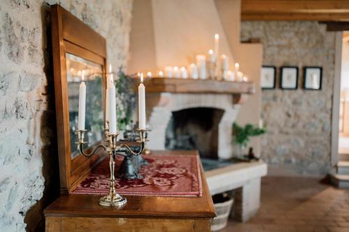 ein Spiegel und Kerzen auf einem Tisch neben einem Kamin in der Unterkunft Agriturismo Il Conte Vassallo in Miane