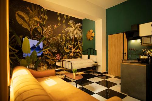 a living room with a couch and a flower mural at Jungle Apartments in Wrocław