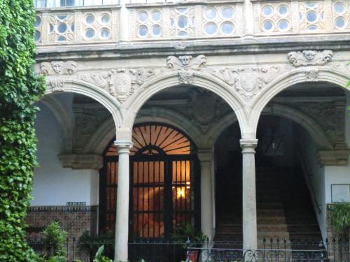 an ornate building with a gate and stairs in front at Palacio de la Rambla in Úbeda