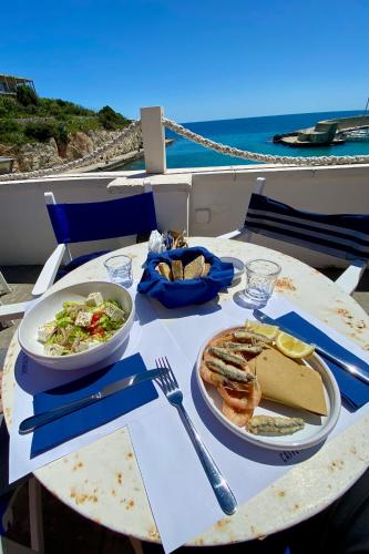 a table with two plates of food on it at B&B SANGIORGIO Green living in Melpignano