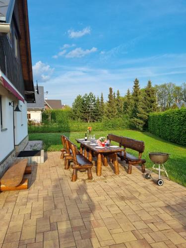 a patio with a table and chairs on a patio at Villa Harta in Vrchlabí