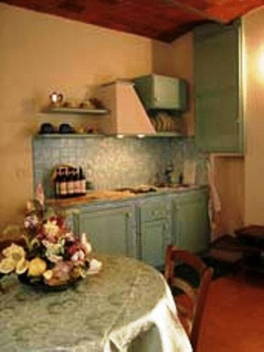 a kitchen with a table and a counter top at Agriturismo La Capitata in Pian di Scò