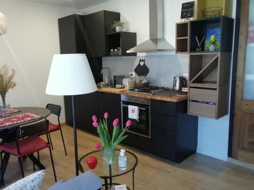a kitchen with a stove and a table with a lamp at LA CASITA in Orvieto