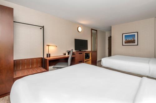 a hotel room with two beds and a desk at Comfort Inn West in Ottawa