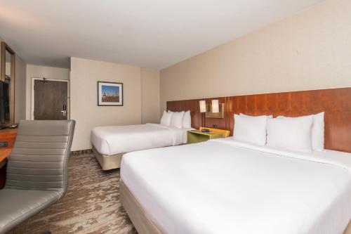 a hotel room with two beds and a couch at Comfort Inn West in Ottawa