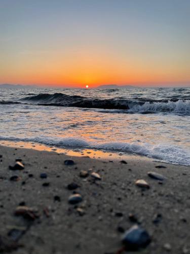 a sunset on a beach with the ocean at Sunset in Trapani