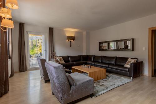 a living room with a couch and a table at Haus Almkreek in Kaprun