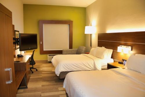 a hotel room with two beds and a flat screen tv at Holiday Inn Express, an IHG Hotel in Douglas