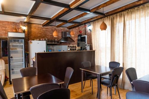 a kitchen and dining room with tables and chairs at Chateau Gremisio in Kvareli