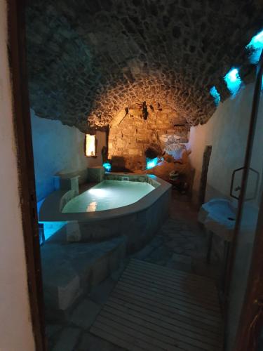 a large bathroom with a tub in a stone building at Il Daviduccio ibla in Ragusa