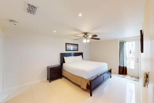 a bedroom with a bed and a ceiling fan at Solare Garden Villa 877 in South Padre Island