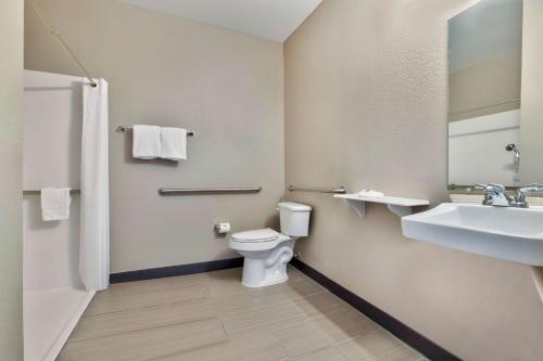 a bathroom with a toilet and a sink at Motel 6-Norman, OK in Norman