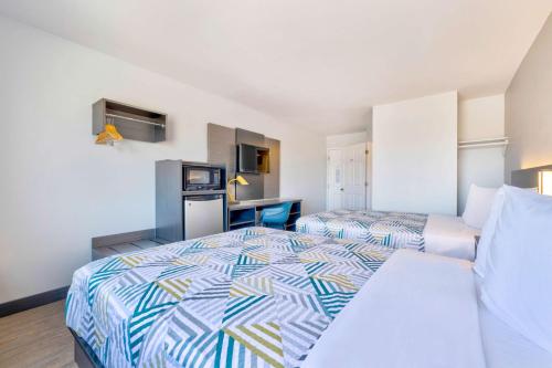 a hotel room with two beds and a kitchen at Motel 6-Norman, OK in Norman