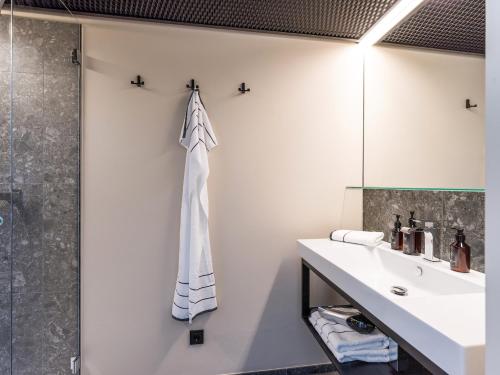 a bathroom with a sink and a shower at Platzhirsch Kufstein in Kufstein