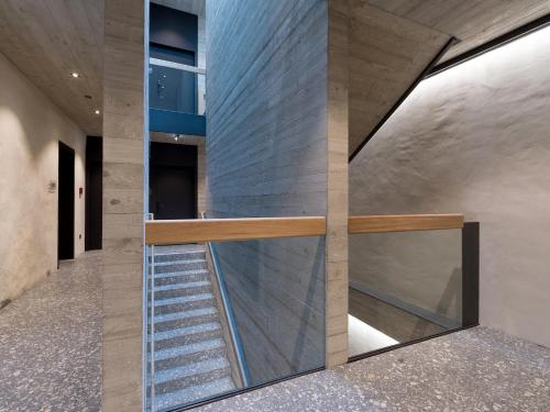 a staircase in a house with a glass wall at Platzhirsch Kufstein in Kufstein