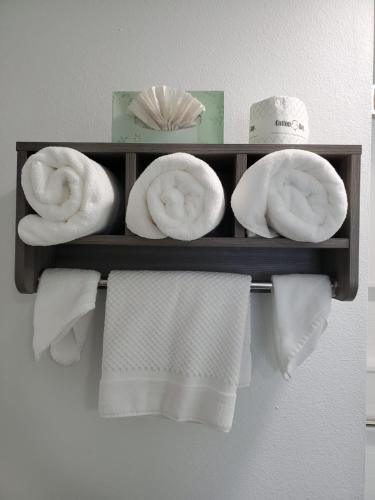 a shelf with towels and hats on a wall at Seven Seas Inn & Suites in Newport