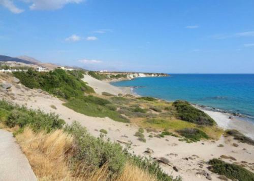 a sandy beach with the ocean in the background at Melissa Apartments in Frangokastello