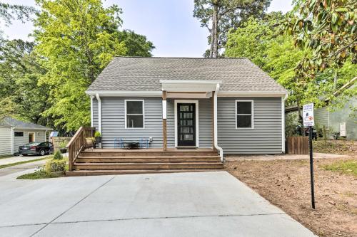 a small house with a porch and a driveway at Freshly Renovated Raleigh Home Near Downtown! in Raleigh