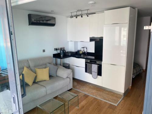 a living room with a couch and a kitchen at Ocean Spa Plaza Resort Apartment in Gibraltar