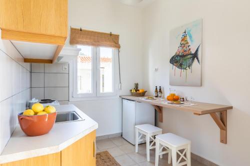 a kitchen with a bowl of fruit on the counter at Seamoon apartment in Skopelos Town