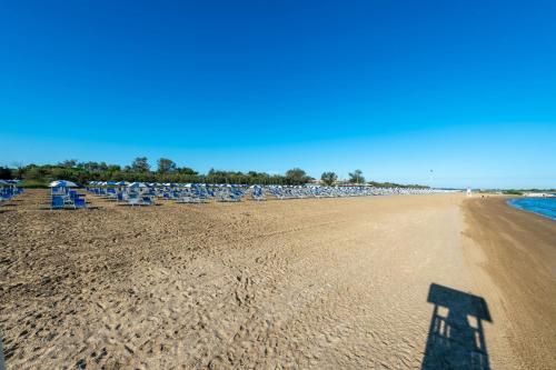 a shadow of a person on the beach at Houses and Apts. in Albarella 24882 in Palazzo Vianello