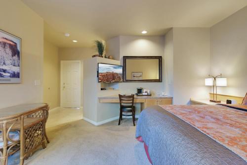 a bedroom with a bed and a desk and a table at River Ridge 513B in Bend