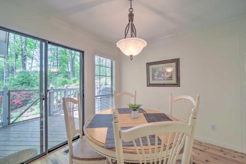 a dining room with a table and chairs and a balcony at Scenic Sapphire Condo with Deck and Gas Grill! in Sapphire
