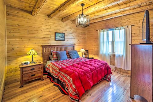 a bedroom with a bed in a log cabin at Beachfront Lake Michigan Log Cabin with Sauna! in Rapid River